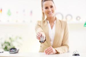 Happy receptionist working in hotel photo