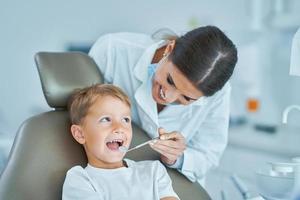 Little boy and female dentist in the dentists office photo