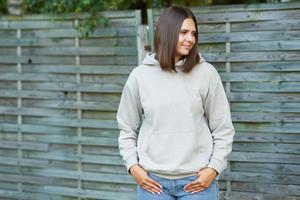 Young woman in beige hoodie. photo