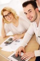 Young couple working on documents at home photo