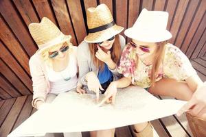 Group of tourists using map in the city photo