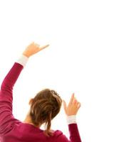 Young woman pointing at white background photo