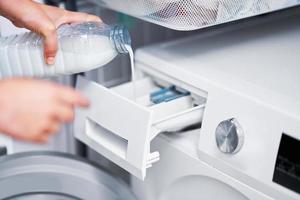 Picture of young woman making laundry work photo