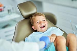 Little boy and female dentist in the dentists office photo