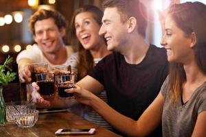 Group Of Friends Enjoying Meal In Restaurant photo