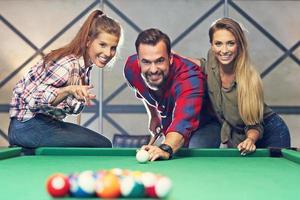 Group of friends playing billards photo