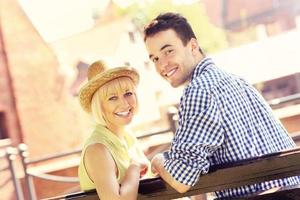 Happy couple resting on a bench photo