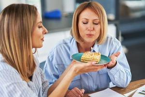 bonitas dos chicas adultas en la casa con pastel de cumpleaños foto