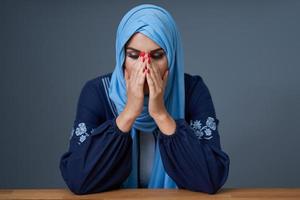 Unhappy muslim female student learning at home photo