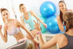 Group of smiling people doing aerobics photo