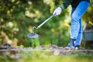 Picture of woman working with tools in the garden photo