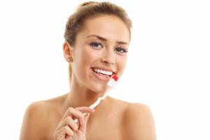 Adult woman with toothbrush isolated on white photo