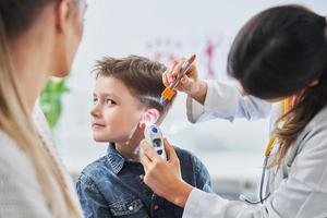 Little boy having medical examination by pediatrician photo