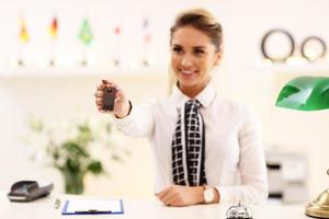 Happy receptionist working in hotel photo