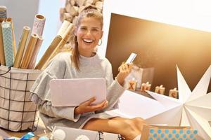 Adult woman at home wrapping Christmas presents photo