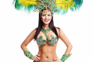 Brazilian woman posing in samba costume over white background photo