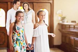 Happy family checking in hotel at reception desk photo