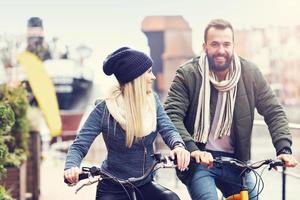 Young couple riding bikes and having fun in the city photo