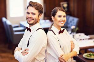 Waiters standing in restaurant photo