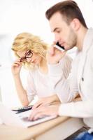 Worried couple with documents at home photo