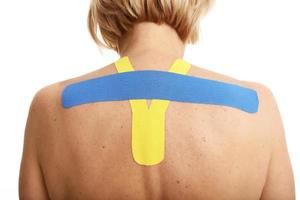 Picture showing special physio tape put on injured back over white background photo