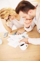 Worried couple with documents at home photo