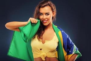 Happy Brazilian fan cheering with flag photo