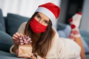 Adult woman with Christmas present at home photo