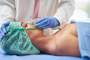 Nurse gives respiratory therapy to a patient recovering in the hospital photo