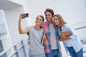 Group of students using smartphone in the campus photo