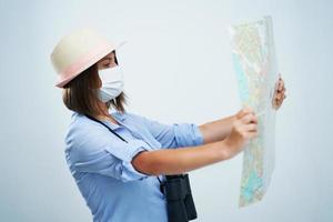 Woman tourist wearing protective mask isolated over white background photo