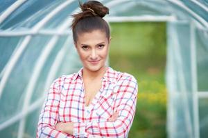 Young Happy woman with garden tools working photo