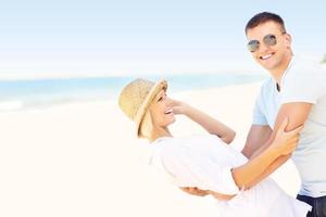 Happy couple dancing at the beach photo