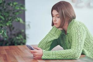 Teenage girl texting at home photo