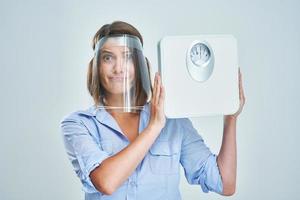 Attractive woman wearing protective mask isolated over white background photo