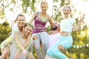 Group of friends having fun at color festival photo