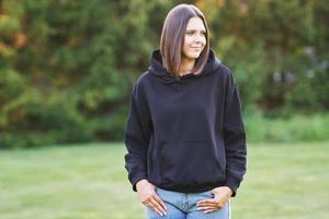 Young woman in black hoodie. photo