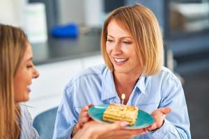 Nice two adult girls in the house with birthday cake photo