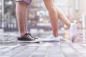 Dating couple's legs on the street in rain photo