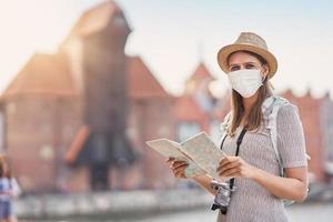 Female tourist wearing a mask sightseeing Gdansk Poland in summer photo