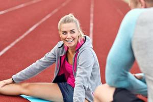 Man and woman racing on outdoor track photo