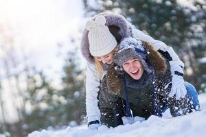 Couple having fun in winter scenery and snow photo