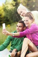 Group of friends camping in forest and taking selfie photo