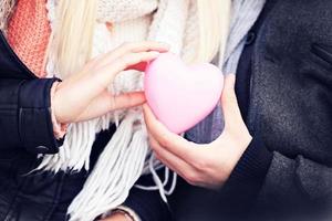 Heart in the hands of young couple photo