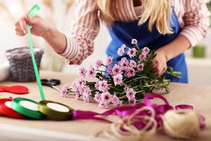 Female florist working in flower shop photo