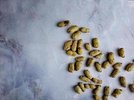 Open peanuts shot macro in studio, white wall texture background photo