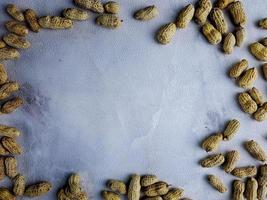 Open peanuts shot macro in studio, white wall texture background photo