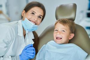 Little boy and female dentist in the dentists office photo