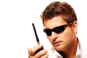 Young security man with radio transmitter photo