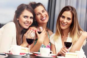 Group of friends chatting in cafe photo